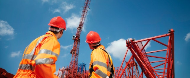 Crane Workers Looking at Cranes